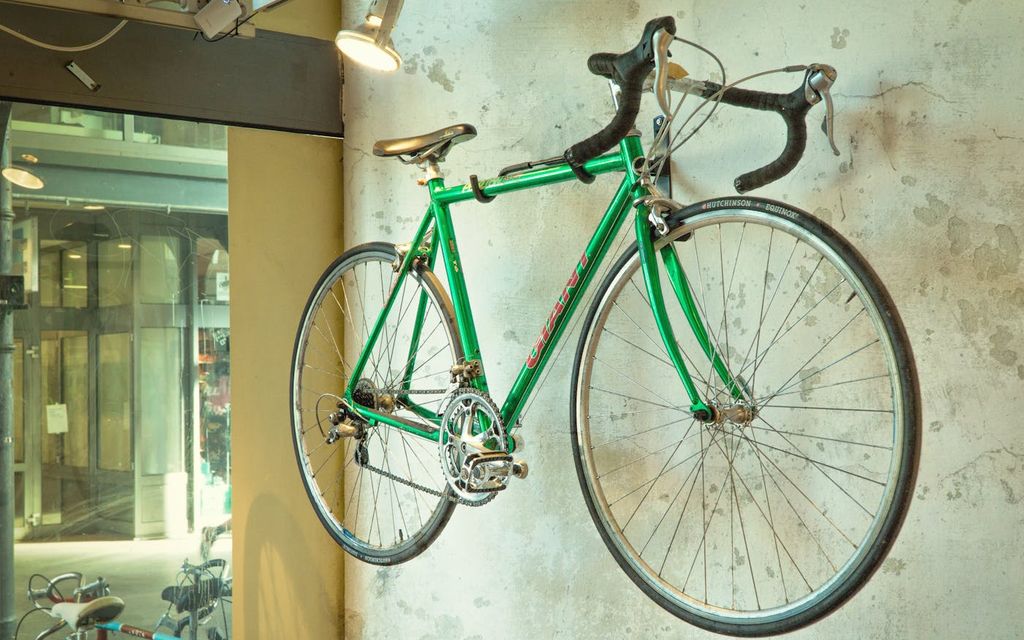 Vélo accroché à un mur par un support mural